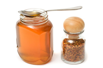 Honey and blossom dust on white background