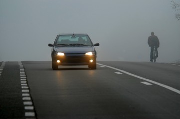 Car appearing through fog 