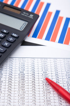 office desk with a calculator and business charts, shallow dof