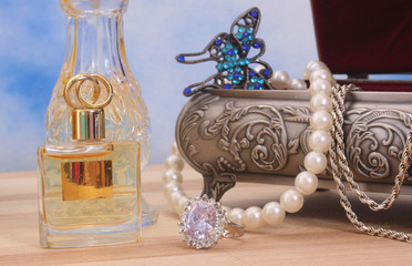 Jewelry and Perfume on Wood With Blue Sky Background