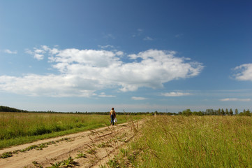 Woman following road. Canicular day, Field.