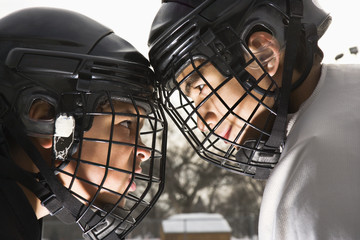 Two ice hockey players in uniform facing off. - 5374506