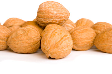 Walnuts on white background, focus on front nut