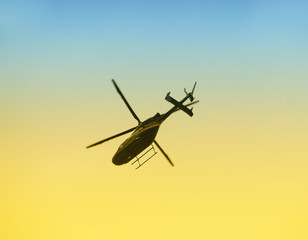 Fototapeta na wymiar Helicopter departing at dawn