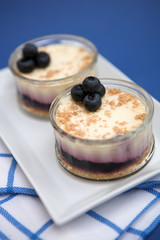 Blueberry cheesecakes served in glass ramekins - shallow dof