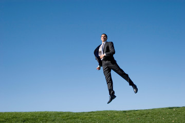 Businessman jumping in the air