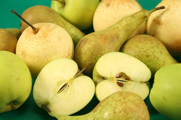 Apples and pears on a green background.