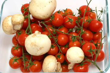Cherry tomato and mushroom in transparent bowl