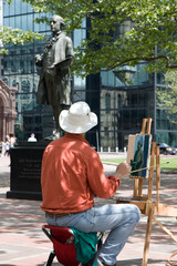 Painter painting a statue