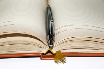 notebook with black office pen 