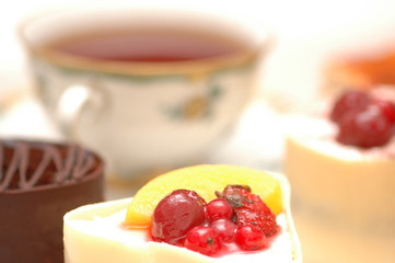 Sweet cake with berries and a cup of tea