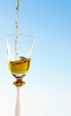 pouring  white wine in goblet