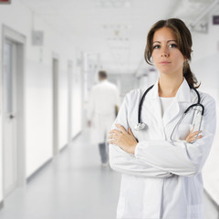 cute brunette in medical gown  and a stethoscope in an hospital