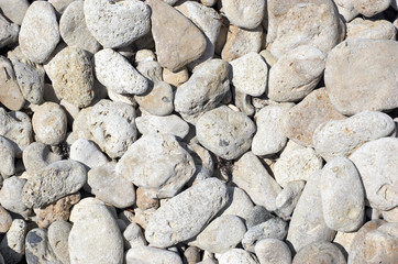 limestone pebbles on the beach under bright sun. texture. © starush