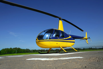 Yellow - Blue helicopter standing in the airport © Alexander Y
