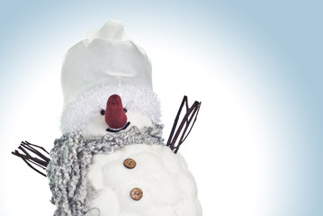 Small, funny snowman smiling over blue background