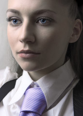 Beautiful girl with tie. She looks forward