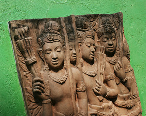 Traditional Thai stone carving on a wall - travel and tourism.