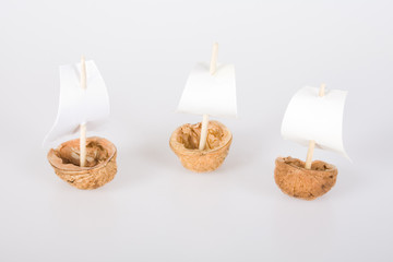 Fototapeta na wymiar Three little boats made from walnut shell