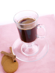 Glass of coffee, cookies and cinnamon