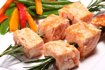 Salmon grilled on the rosemary skewers with vegetables