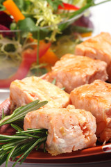 Salmon grilled on the rosemary skewers with vegetables..