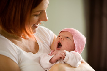 Mother holding newborn baby girl
