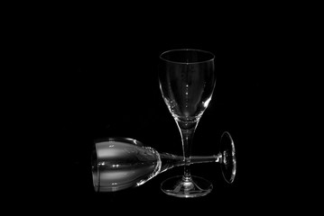 thin wine glasses againt a black background