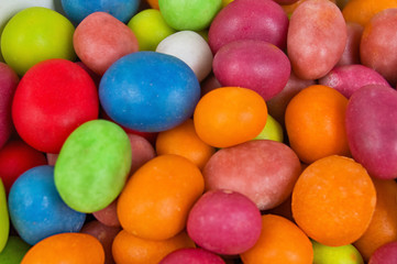 Fototapeta na wymiar A full background of brightly colored candies