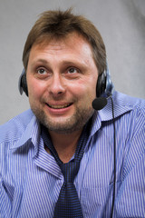 attentive receptionist with headset looking on a customer