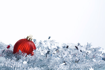 Horizontal image: christmas red ball and silver tinsel