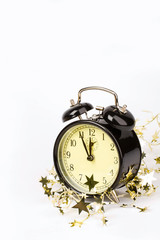Image of clock with gold tinsel on a white background