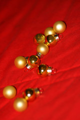 Christmas toy. Small Golden Baubles on Red
