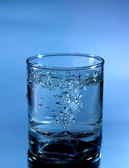Glass of pouring water