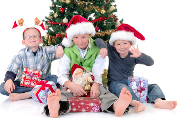 Obraz na płótnie Canvas happy youngsters, three boys in front of Xmas, Christmas 