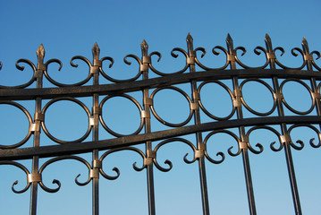 Metal fence over blue sky