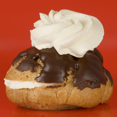 a chocolate eclair with whipped cream 