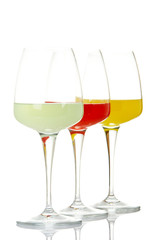 Beverages, reflected on white background. Shallow DOF