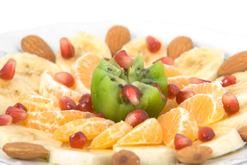 Naklejka na ściany i meble Delicious fruit salad on white round plate isolated on white