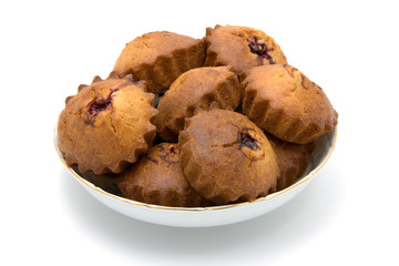 Tasty baked cakes in white bowl with shadow isolated on white