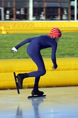 Young man speed ice skating in the Netherlands