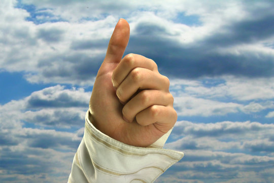 Female hand with thum raise up.