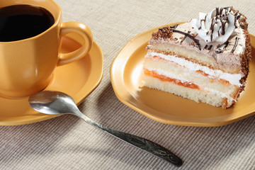 Ceramic cup of coffee and plate with slice of cake