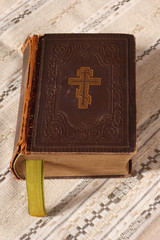 Old Orthodox bible on linen napkin