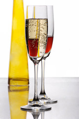 two champaigne glasses with yellow bottle