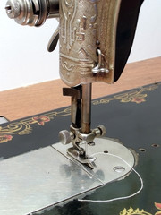 Old metal sewing machine over white background