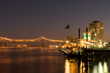 Hotels and bridge over Mississippi river at dusk, New Orleans
