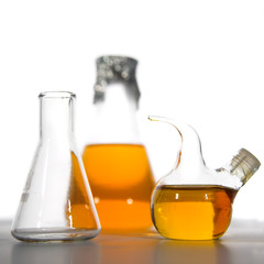 isolated laboratory glass with yellow solution