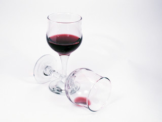 Two wineglasses with red wine on white background