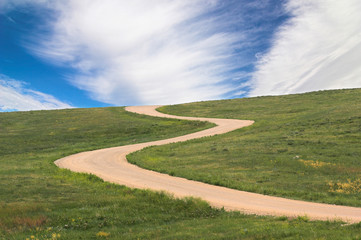 twisty road leading to blue sky, concept shot